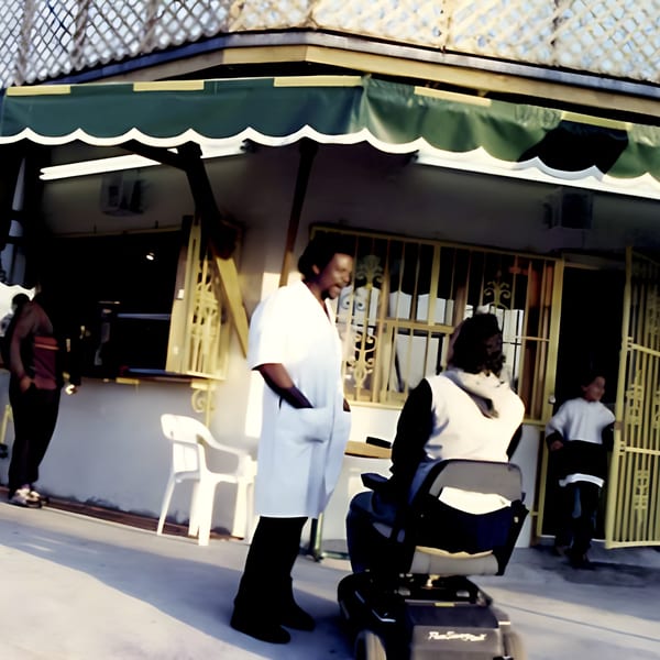 People gathered outside Naomi's Garden Restaurant & Lounge under a green and white awning.